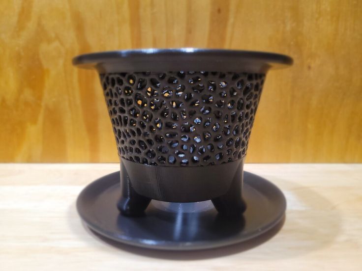Black aerated orchid pot with open texture and matching round saucer